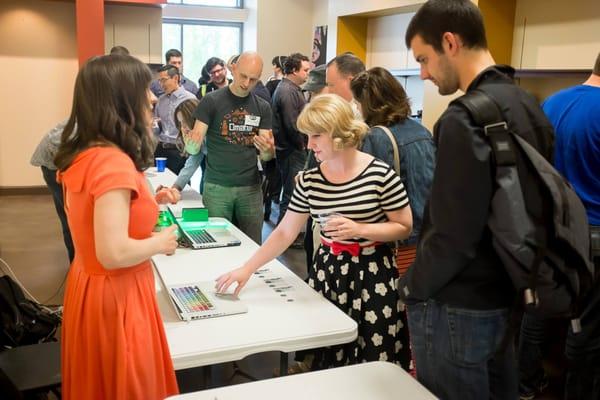 Visitors check out student work during the demos portion of the graduation celebration.