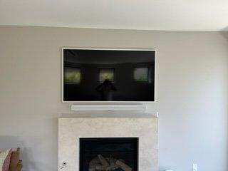 A Samsung 75" Frame TV with a white SONOS ARC soundbar.