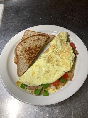 Omelet with peppers, onions, tomatoes, cheese, and sausage