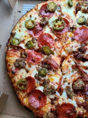 Pepperoni, sausage, jalapeños pizza